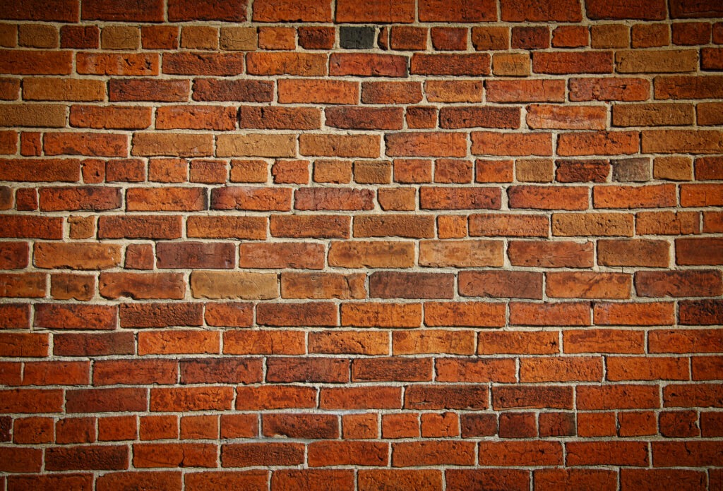 Weathered stained old brick wall background